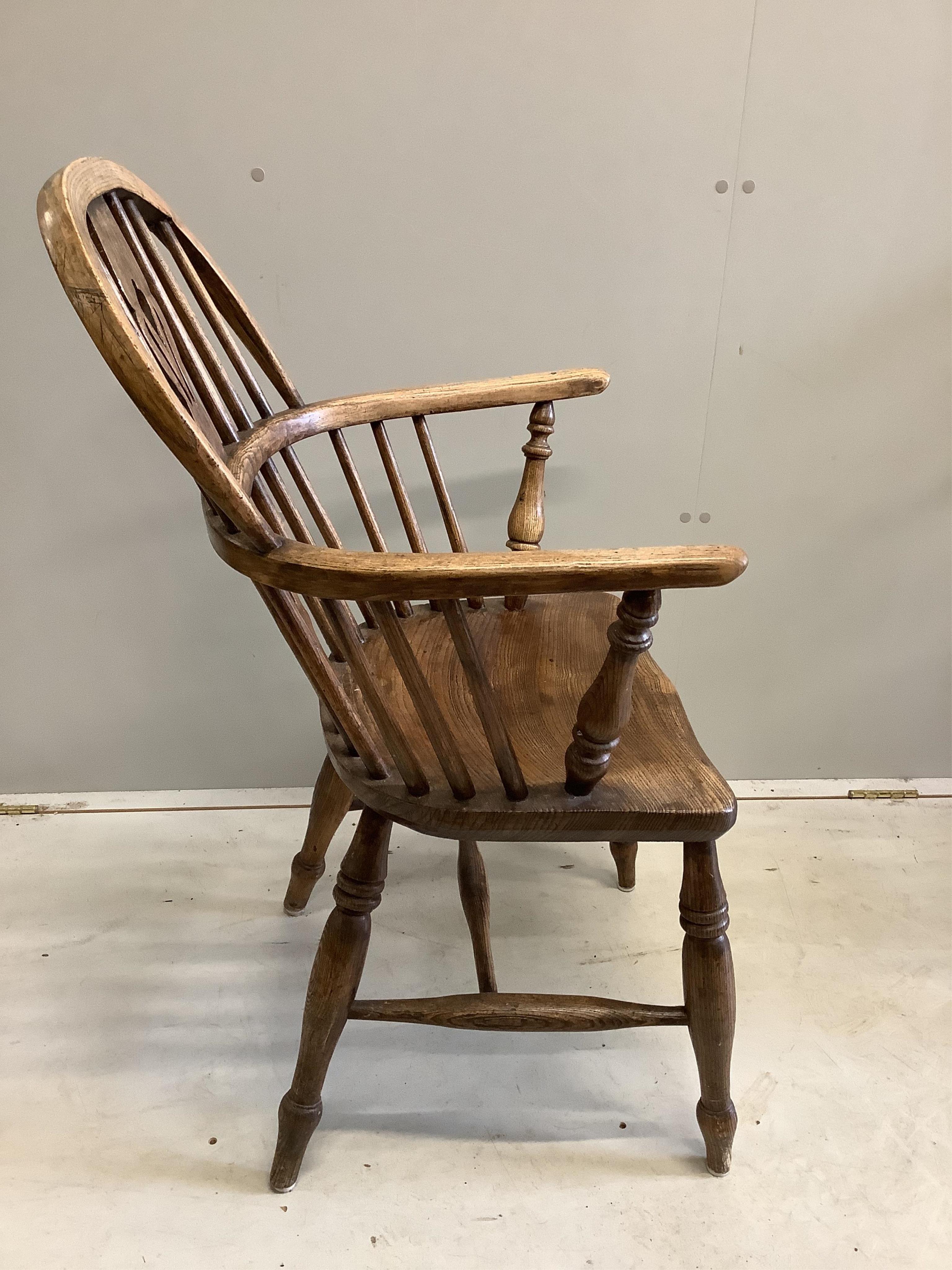 A harlequin set of four 19th century ash, elm and beech Windsor elbow chairs, largest width 60cm, depth 36cm, height 95cm. Condition - fair